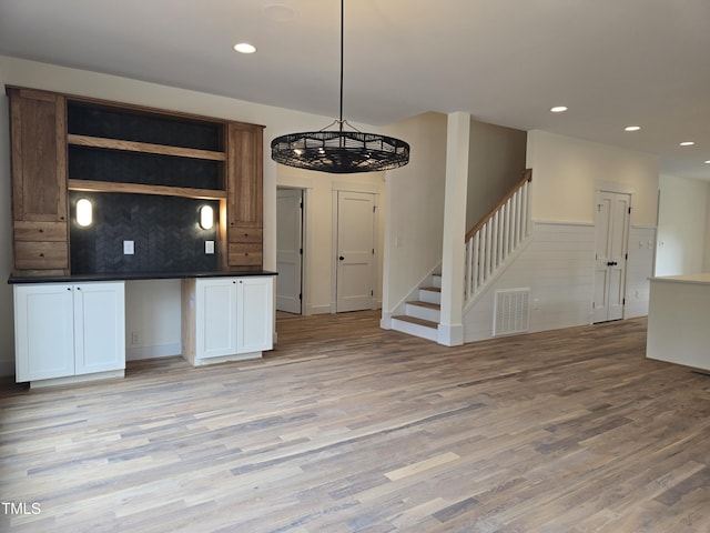 kitchen with visible vents, open shelves, light wood-style flooring, decorative backsplash, and dark countertops