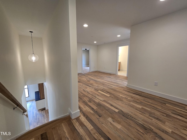 interior space featuring recessed lighting, baseboards, and wood finished floors