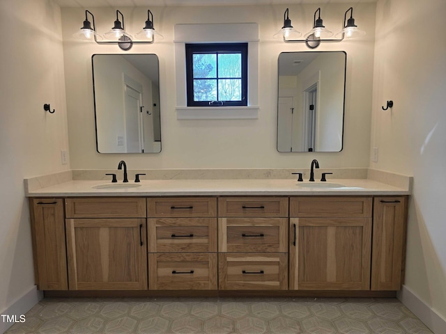 full bath featuring a sink, baseboards, and double vanity