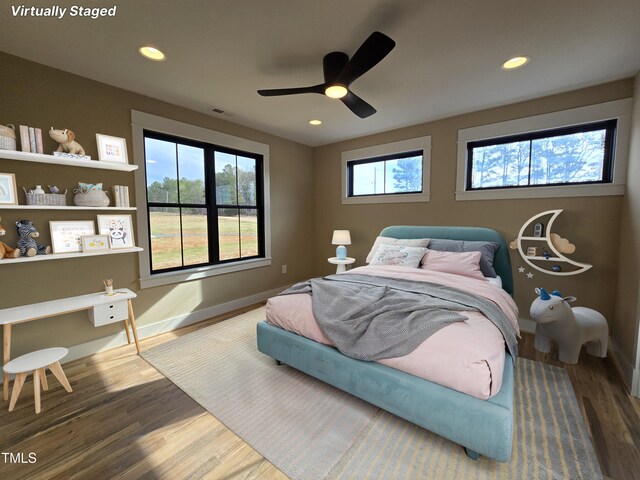 bedroom featuring baseboards, visible vents, wood finished floors, and recessed lighting