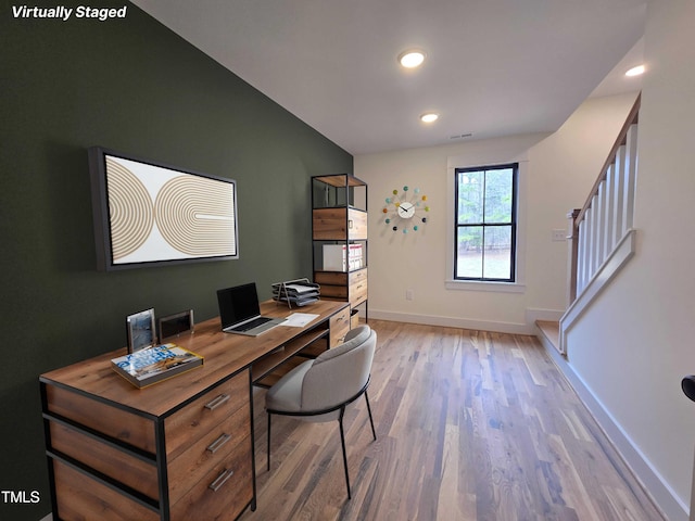 office space featuring baseboards, light wood-type flooring, visible vents, and recessed lighting