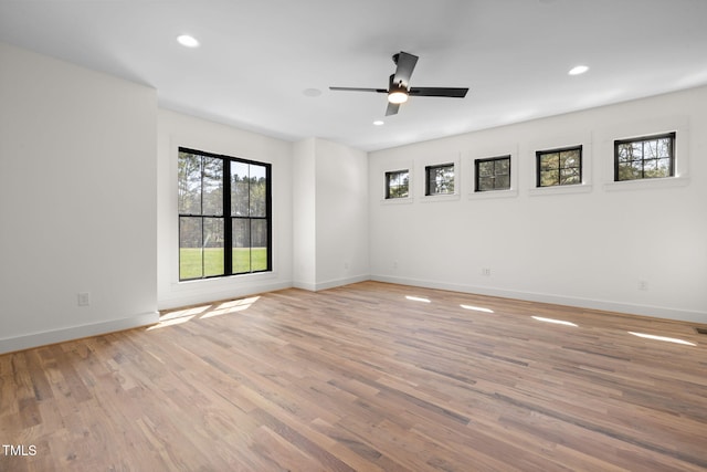 spare room featuring baseboards, a ceiling fan, recessed lighting, and light wood-type flooring