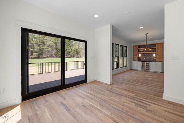 interior space with light wood finished floors, baseboards, and recessed lighting