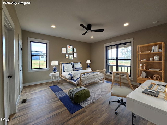 bedroom with baseboards, visible vents, wood finished floors, and recessed lighting
