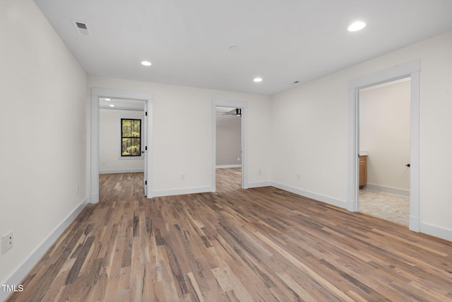 spare room with visible vents, wood finished floors, and recessed lighting