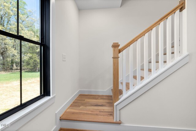 stairs featuring baseboards and wood finished floors