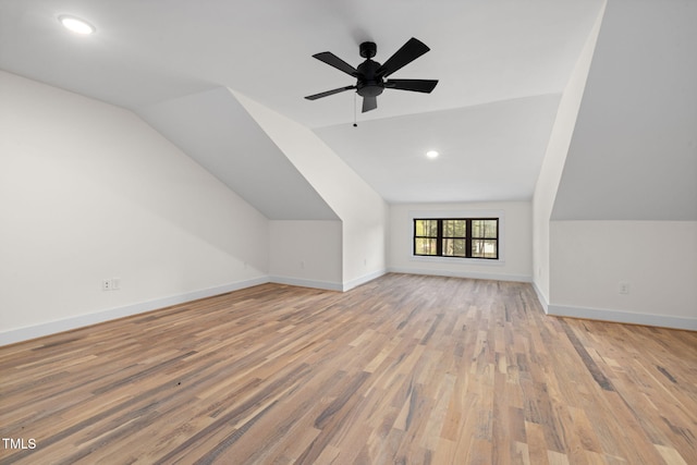 additional living space featuring baseboards, ceiling fan, vaulted ceiling, and light wood finished floors