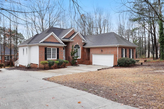 view of front of house with an attached garage, brick siding, driveway, and a shingled roof