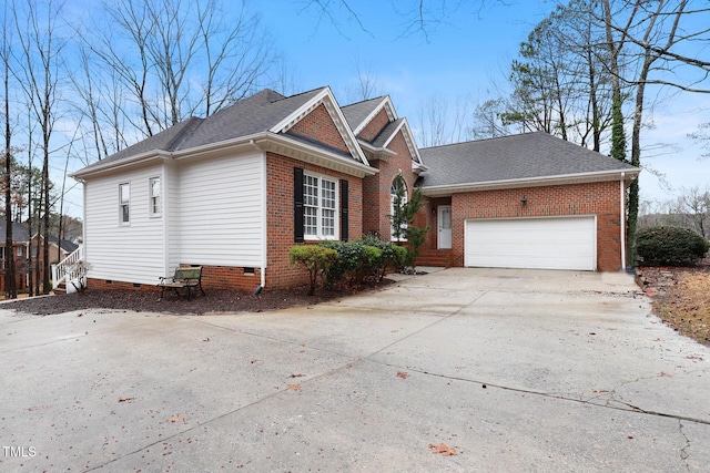 view of property exterior featuring brick siding, concrete driveway, roof with shingles, a garage, and crawl space