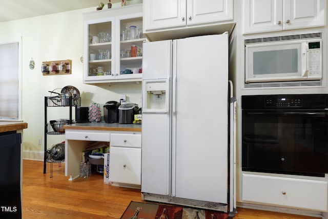 kitchen featuring light wood-style flooring, white appliances, glass insert cabinets, and white cabinets