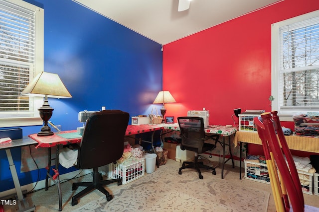 office area with carpet, a ceiling fan, and baseboards