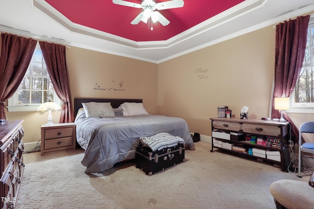 bedroom featuring a tray ceiling, carpet flooring, and crown molding