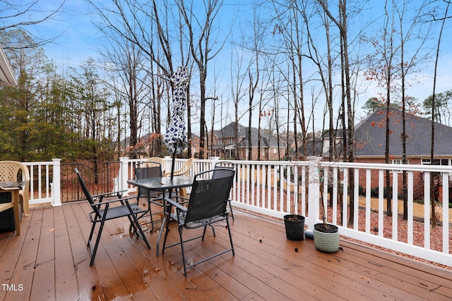 wooden terrace with outdoor dining space