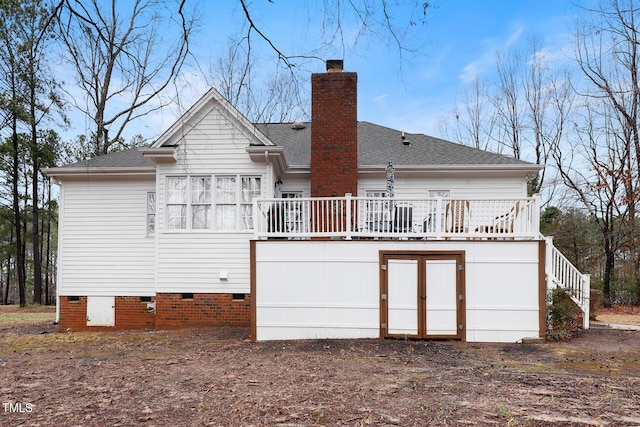 back of property featuring crawl space, roof with shingles, a deck, and a chimney