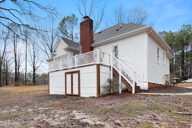 back of property featuring stairs, a wooden deck, a shingled roof, crawl space, and a chimney