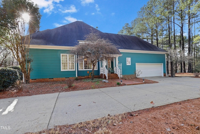 single story home featuring crawl space, a garage, roof with shingles, and concrete driveway