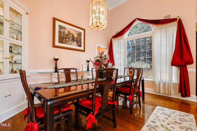 dining space featuring an inviting chandelier and wood finished floors