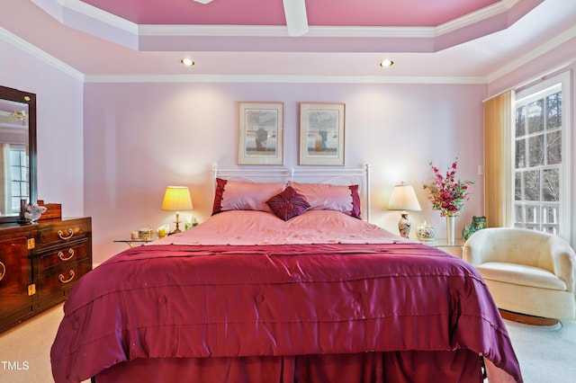 carpeted bedroom with multiple windows, crown molding, and a raised ceiling