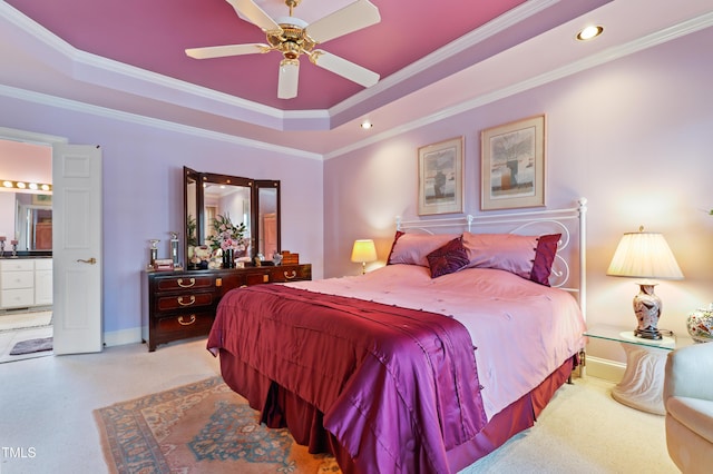 bedroom featuring ornamental molding, a tray ceiling, recessed lighting, baseboards, and light colored carpet