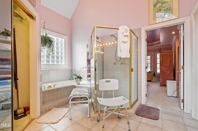 full bath featuring lofted ceiling, a garden tub, a stall shower, and tile patterned flooring