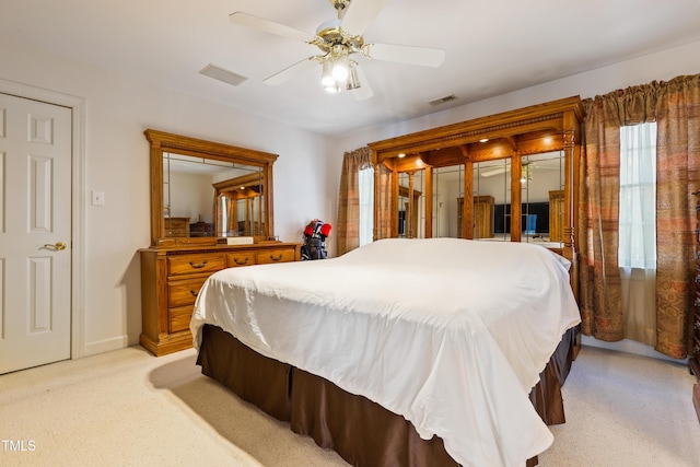 bedroom featuring visible vents, light carpet, and ceiling fan