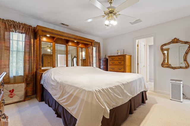 bedroom with visible vents, light carpet, and baseboards