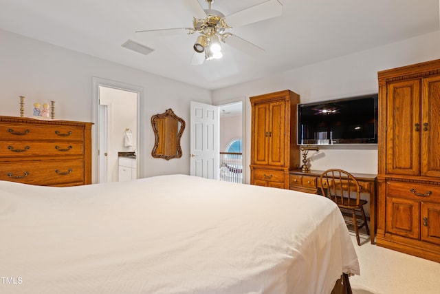 bedroom featuring visible vents, ensuite bathroom, and ceiling fan