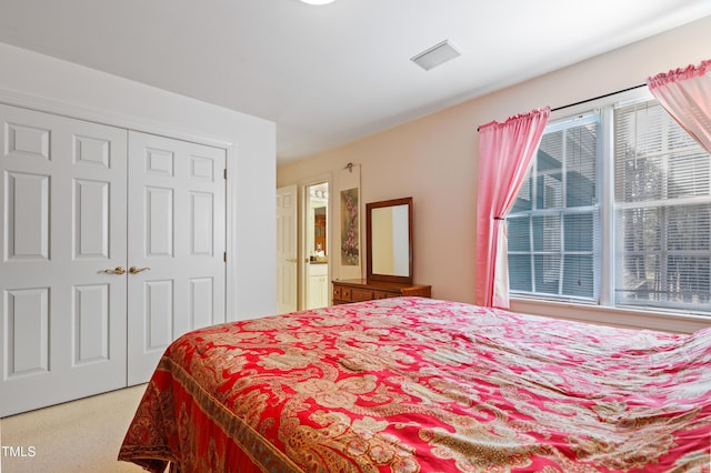 bedroom featuring a closet and visible vents