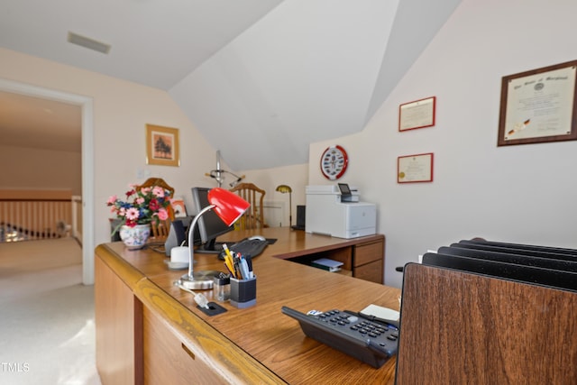 home office with lofted ceiling, light colored carpet, and visible vents