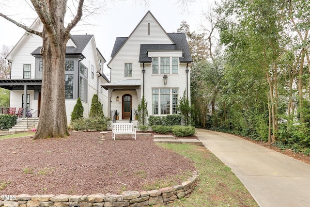 view of front of property with roof with shingles and metal roof