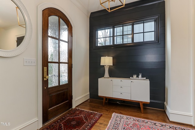 entryway featuring baseboards and wood finished floors