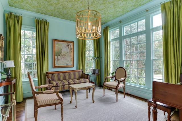 sitting room with a healthy amount of sunlight, an ornate ceiling, and a chandelier