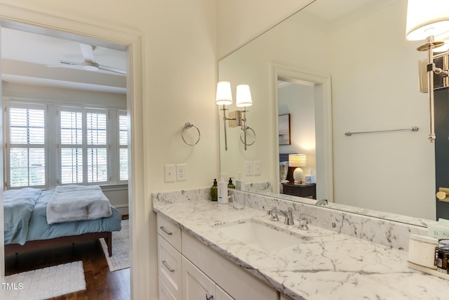 ensuite bathroom featuring ensuite bathroom, wood finished floors, and vanity