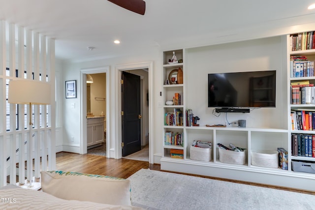 bedroom featuring ensuite bath, wood finished floors, and recessed lighting