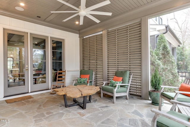 sunroom / solarium featuring a ceiling fan and wood ceiling