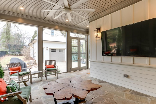 sunroom featuring wood ceiling and a ceiling fan