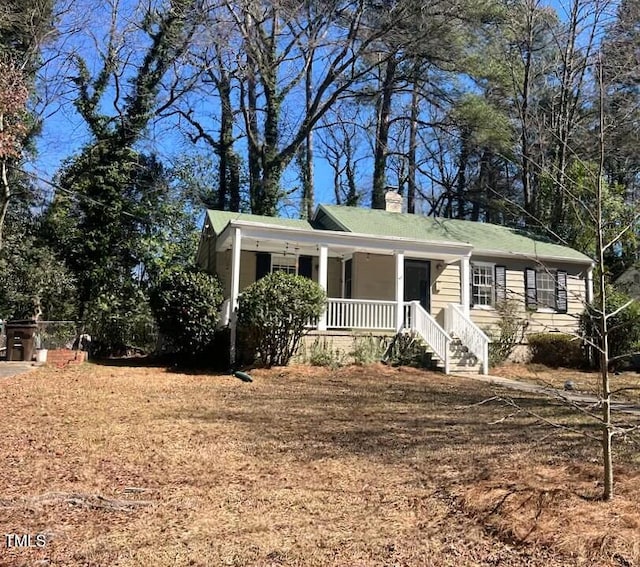 view of front of home with a porch and a chimney