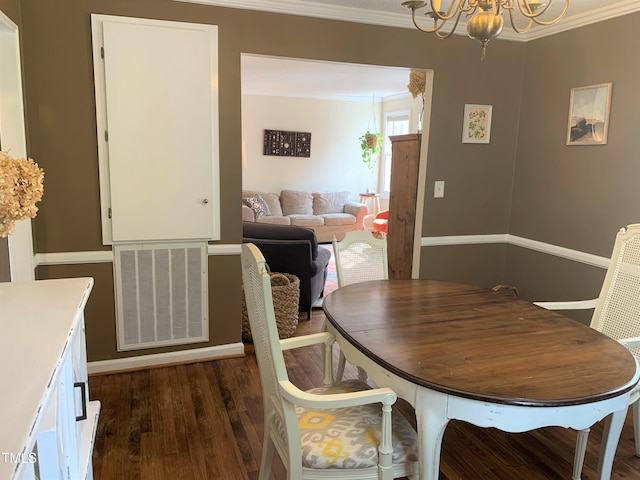 dining room featuring dark wood-style floors, visible vents, ornamental molding, and an inviting chandelier