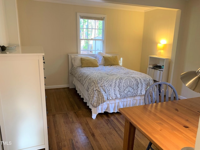 bedroom with wood finished floors and baseboards