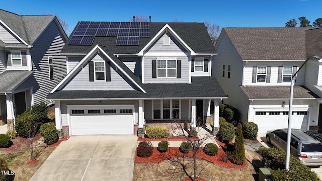 view of front of home featuring an attached garage, a porch, concrete driveway, and brick siding