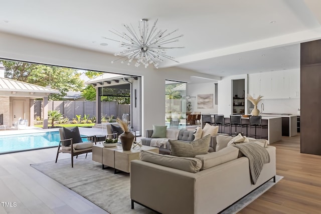 living area featuring an inviting chandelier and light wood-style flooring