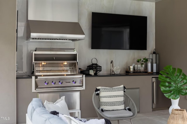 interior details with wall chimney range hood and a sink