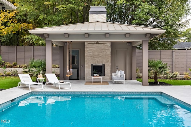 view of pool with a patio area, a fenced in pool, an outdoor structure, and fence