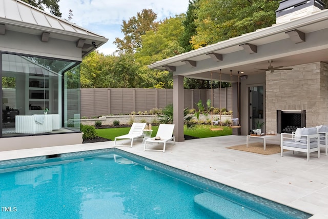 view of swimming pool featuring a patio area, a fenced in pool, ceiling fan, and fence