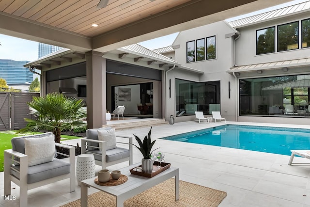 outdoor pool featuring outdoor lounge area and a patio area