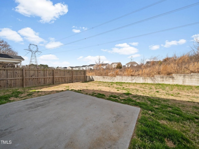 view of yard featuring fence and a patio