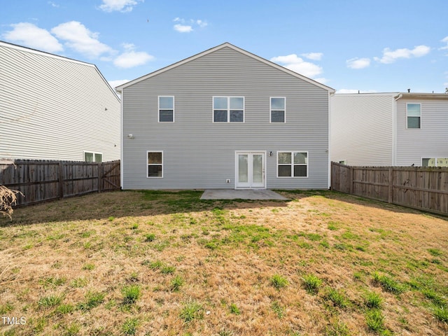 rear view of property featuring a patio area, a fenced backyard, and a lawn