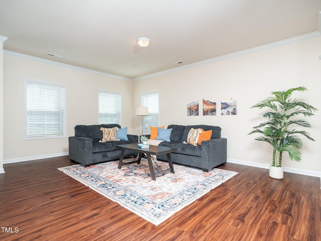 living area with baseboards, wood finished floors, and crown molding