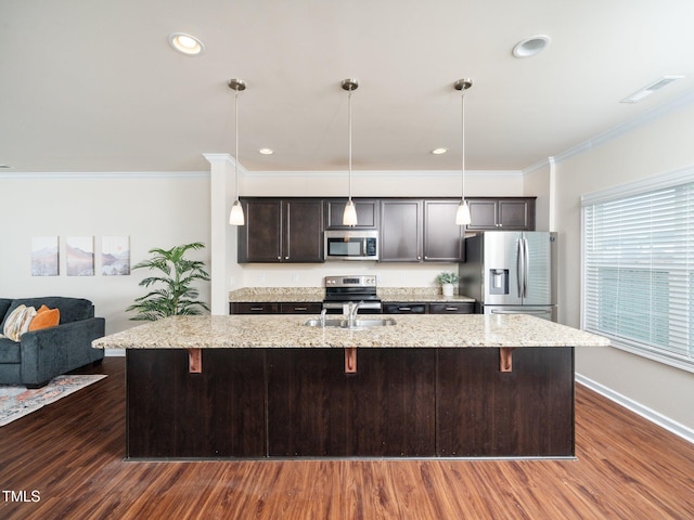 kitchen featuring stainless steel appliances, dark wood-style flooring, visible vents, ornamental molding, and a kitchen bar