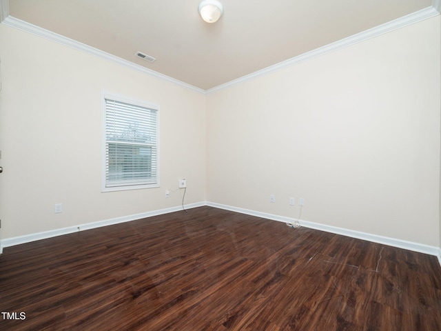 spare room with ornamental molding, visible vents, dark wood finished floors, and baseboards